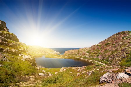 Mountain lake in the North. Moss-covered hills, and stunted vegetation. The Kola Peninsula. Fotografie stock - Microstock e Abbonamento, Codice: 400-07515256