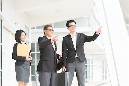 simsearch:400-07515329,k - Asian business team meeting, pointing over and having discussion. Modern office background. Stock Photo - Budget Royalty-Free & Subscription, Code: 400-07515309