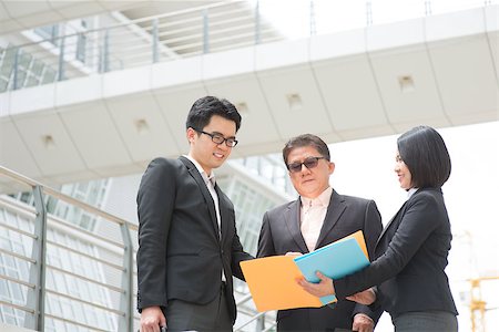 simsearch:400-07515329,k - Asian business team meeting, showing report to CEO and having discussion. Modern office background. Stock Photo - Budget Royalty-Free & Subscription, Code: 400-07515310