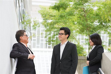simsearch:400-07515329,k - Asian business team chatting during business break outside office. Stock Photo - Budget Royalty-Free & Subscription, Code: 400-07515311