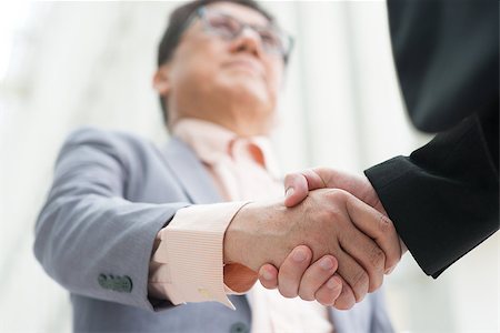 simsearch:400-07515329,k - Business greeting, Asian businessmen handshaking. Chinese CEO boss. Focus on hands. Modern  office building architecture background. Stock Photo - Budget Royalty-Free & Subscription, Code: 400-07515326