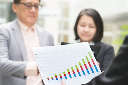 simsearch:400-07515329,k - Asian business team meeting. Young business executive presenting charts to CEO boss over office. Stock Photo - Budget Royalty-Free & Subscription, Code: 400-07515328