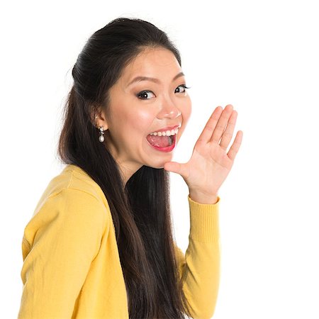 portrait screaming girl - Asian woman holding hand beside her cheek and shouts an announcement, isolated on white background Stock Photo - Budget Royalty-Free & Subscription, Code: 400-07515335