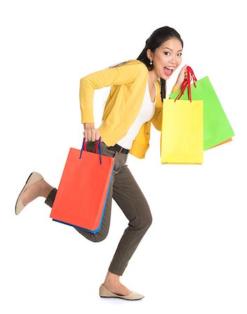 Full body Asian woman running with shopping bags, isolated on white background. Stock Photo - Budget Royalty-Free & Subscription, Code: 400-07515342