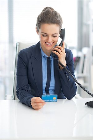 simsearch:400-06642775,k - Business woman with credit card talking phone Photographie de stock - Aubaine LD & Abonnement, Code: 400-07516779