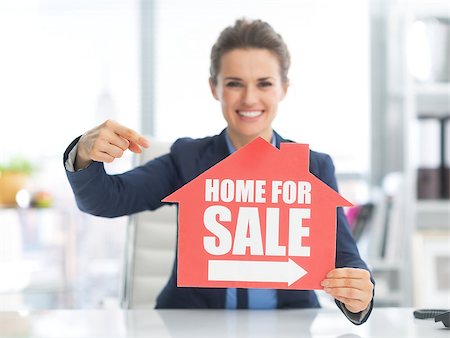 female agent - Happy realtor woman pointing on home for sale sign Stock Photo - Budget Royalty-Free & Subscription, Code: 400-07516789