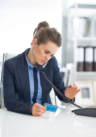 simsearch:400-07106831,k - Business woman with credit card dialing phone Stockbilder - Microstock & Abonnement, Bildnummer: 400-07516780