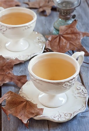 Green tea in vintage mugs on wooden table with dry fall leaves. Selective focus. Stock Photo - Budget Royalty-Free & Subscription, Code: 400-07516986