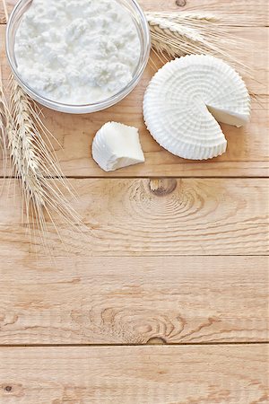 Tzfat cheese and cottage cheese with wheat grains. Symbols of judaic holiday Shavuot. Copy space background. Stock Photo - Budget Royalty-Free & Subscription, Code: 400-07516982