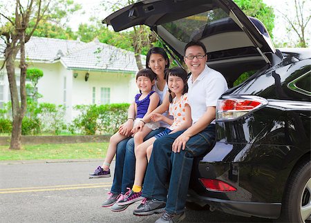 happy family sitting in the car and their house behind Stock Photo - Budget Royalty-Free & Subscription, Code: 400-07517986