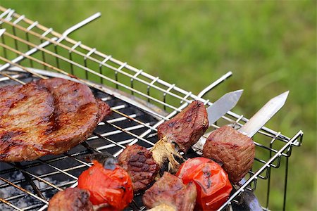 simsearch:400-07518553,k - Cooking on the barbecue grill assortment sausages steak and skewers Photographie de stock - Aubaine LD & Abonnement, Code: 400-07518555