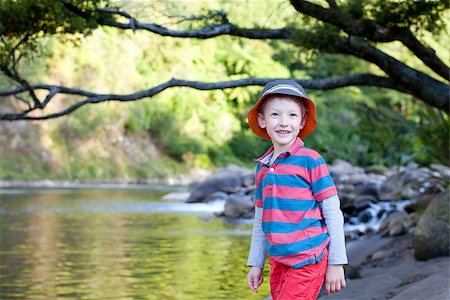 handsome smiling boy standing by the river Photographie de stock - Aubaine LD & Abonnement, Code: 400-07518808