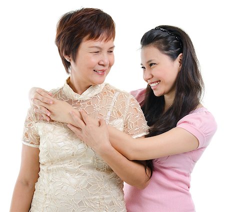 Adult daughter embraces mother isolated on white background. Mixed race Asian family portrait. Stock Photo - Budget Royalty-Free & Subscription, Code: 400-07518992