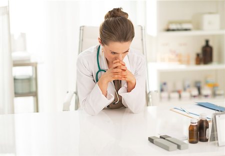 simsearch:400-07519214,k - Concerned medical doctor woman sitting in office Stock Photo - Budget Royalty-Free & Subscription, Code: 400-07519137