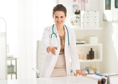 simsearch:400-07519214,k - Smiling medical doctor woman in office stretching hand for handshake Stock Photo - Budget Royalty-Free & Subscription, Code: 400-07519132