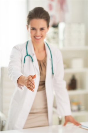 simsearch:400-07519214,k - Closeup on smiling medical doctor woman in office stretching hand for handshake Stock Photo - Budget Royalty-Free & Subscription, Code: 400-07519133