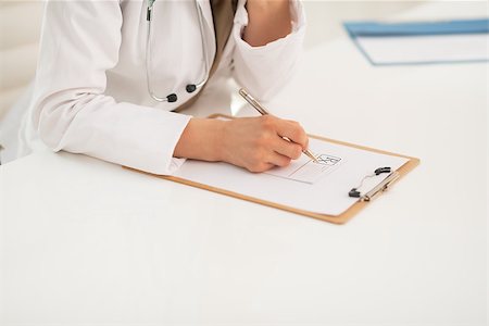 simsearch:400-07099882,k - Closeup on medical doctor woman writing in clipboard Photographie de stock - Aubaine LD & Abonnement, Code: 400-07519149