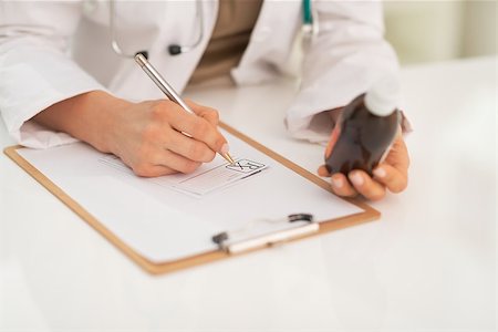 simsearch:400-07099832,k - Closeup on medical doctor woman writing prescription Stock Photo - Budget Royalty-Free & Subscription, Code: 400-07519154