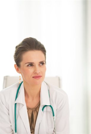 simsearch:400-07519214,k - Medical doctor woman sitting in office and looking on copy space Stock Photo - Budget Royalty-Free & Subscription, Code: 400-07519196