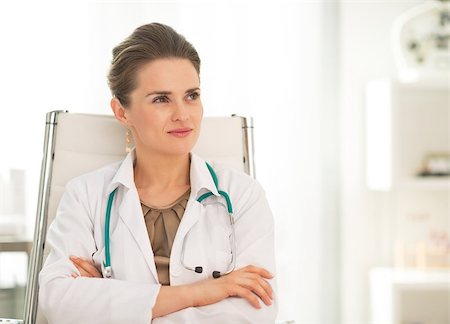 simsearch:400-07519214,k - Medical doctor woman sitting in office and looking on copy space Stock Photo - Budget Royalty-Free & Subscription, Code: 400-07519197