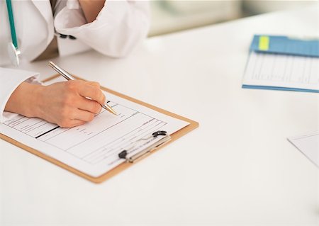 simsearch:400-07519214,k - Closeup on medical doctor woman writing in clipboard Stock Photo - Budget Royalty-Free & Subscription, Code: 400-07519206