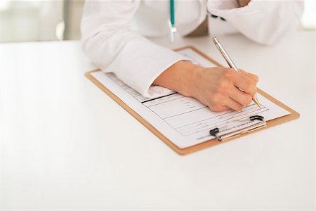 simsearch:400-07519214,k - Closeup on medical doctor woman writing in clipboard Stock Photo - Budget Royalty-Free & Subscription, Code: 400-07519207