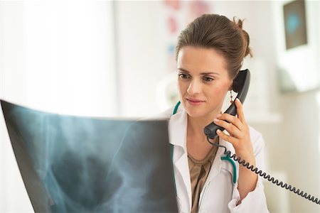 simsearch:400-07519214,k - Medical doctor woman looking on fluorography and talking phone Stock Photo - Budget Royalty-Free & Subscription, Code: 400-07519223