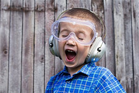 Little boy with safety glasses on wooden background Stock Photo - Budget Royalty-Free & Subscription, Code: 400-07510370