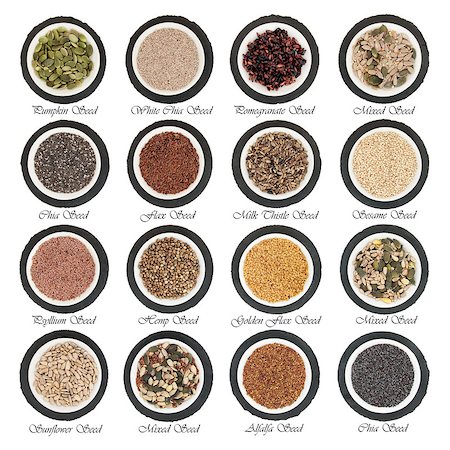 flax seeds - Large seed super food selection in  porcelain bowls over slate rounds and white isolated background with titles. Stock Photo - Budget Royalty-Free & Subscription, Code: 400-07510803