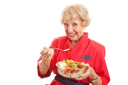 simsearch:649-07559812,k - Pretty senior woman stays fit and eats healthy salad.  Isolated on white. Stock Photo - Budget Royalty-Free & Subscription, Code: 400-07510947