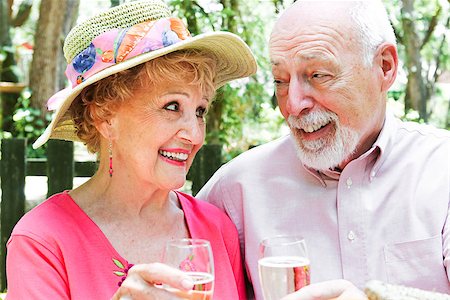 Beautiful retired senior couple toasting each other with champagne in an outdoor setting. Stock Photo - Budget Royalty-Free & Subscription, Code: 400-07510943