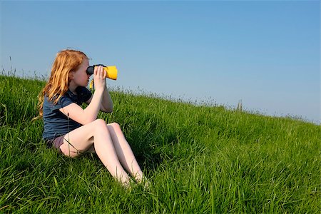 simsearch:400-06744095,k - Young girl with binoculars in a meadow searching the sky Stock Photo - Budget Royalty-Free & Subscription, Code: 400-07511373