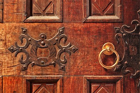 Closeup of old ornate wooden door with a gold door handle in Alba, Italy. Stock Photo - Budget Royalty-Free & Subscription, Code: 400-07511790