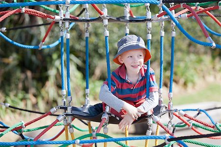 cheerful positive boy spending fun time at the playground Stock Photo - Budget Royalty-Free & Subscription, Code: 400-07511828