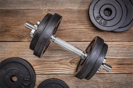 simsearch:400-07620929,k - exercise weights - iron dumbbell with extra plates on a rustic wooden deck Stock Photo - Budget Royalty-Free & Subscription, Code: 400-07512141