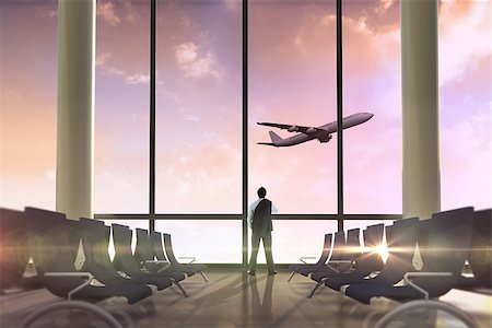 Businessman holding his jacket against airplane flying past departures lounge Stock Photo - Budget Royalty-Free & Subscription, Code: 400-07512331