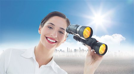 Smiling business woman with binoculars against cityscape on the horizon Stock Photo - Budget Royalty-Free & Subscription, Code: 400-07512399