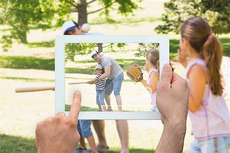 family with tablet in the park - Hand holding tablet pc showing father playing baseball with his children Photographie de stock - Aubaine LD & Abonnement, Code: 400-07512437
