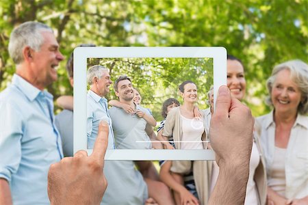 family with tablet in the park - Hand holding tablet pc showing extended family spending time in the park Photographie de stock - Aubaine LD & Abonnement, Code: 400-07512438