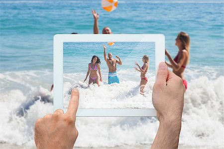 simsearch:400-07664794,k - Hand holding tablet pc showing young friends having fun at the beach Stock Photo - Budget Royalty-Free & Subscription, Code: 400-07512433