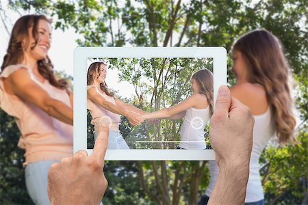 family with tablet in the park - Hand holding tablet pc showing mother and daughter in the park Stock Photo - Budget Royalty-Free & Subscription, Code: 400-07512465