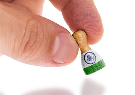 Hand holding wooden pawn with a flag painting, selective focus, India Stock Photo - Budget Royalty-Free & Subscription, Code: 400-07512818