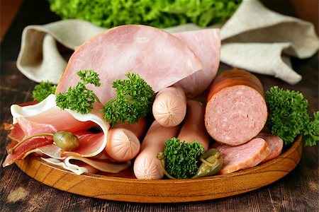 simsearch:400-06063216,k - various kinds of sausages and smoked bacon on the wooden plate Fotografie stock - Microstock e Abbonamento, Codice: 400-07513362