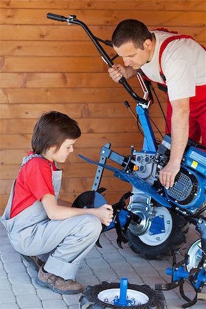 Boy helps his father mounting a tiller head on a cultivator machine Stock Photo - Budget Royalty-Free & Subscription, Code: 400-07524299