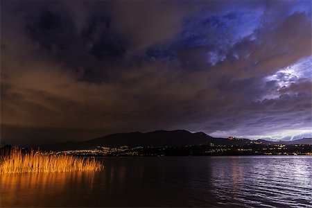 Thunderstorm at the horizon, lake of Varese - Lombardy, Italy Fotografie stock - Microstock e Abbonamento, Codice: 400-07524478