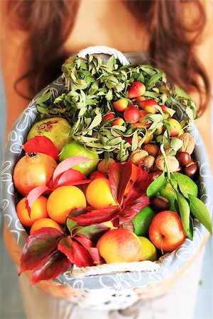 Photo of girl holding basket with fruits Stock Photo - Budget Royalty-Free & Subscription, Code: 400-07525170