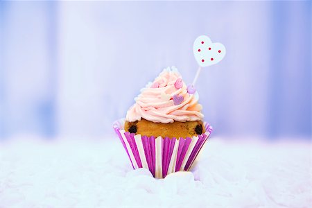 Photo of cute cupcake on wooden background Stock Photo - Budget Royalty-Free & Subscription, Code: 400-07525180