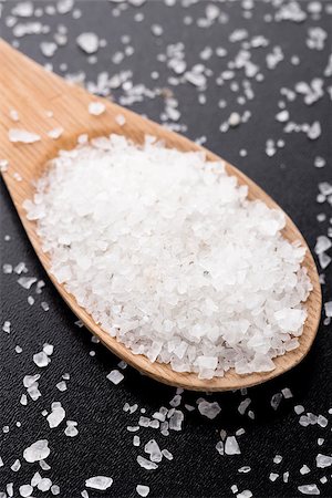 simsearch:400-08376668,k - Sea salt in wooden spoon on a black table Stock Photo - Budget Royalty-Free & Subscription, Code: 400-07525342