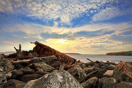 ship in stormy sea - The setting sun highlights and backlights the rusting twisted metal remains of the SS Minmi that tragically shipwrecked in Botany Bay Sydney in 1937. Stock Photo - Budget Royalty-Free & Subscription, Code: 400-07525501