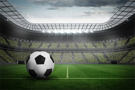 soccer fans in stadium - Black and white leather football in a large football stadium with fans in yellow Stock Photo - Budget Royalty-Free & Subscription, Code: 400-07525749